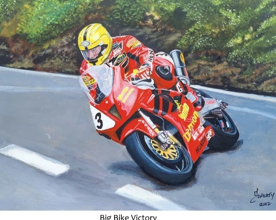Joey Dunlop crossing the line with his arm raised in victory