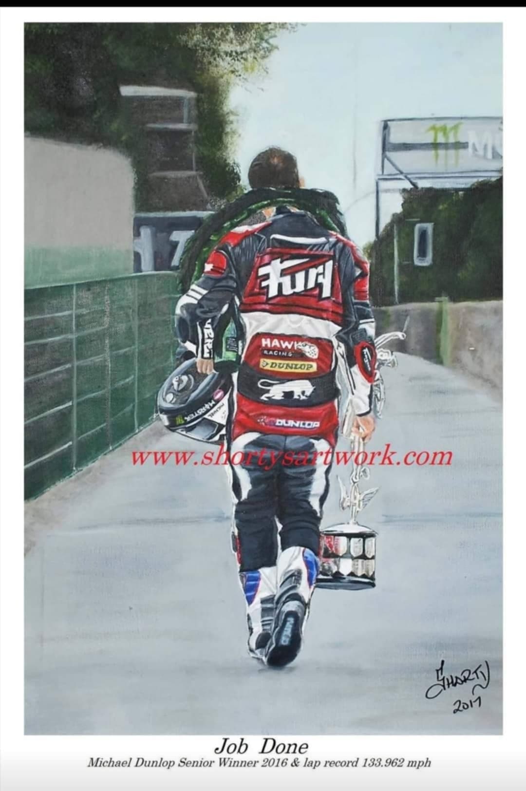 Michael Dunlop walking away with helmet and trophy after a TT win